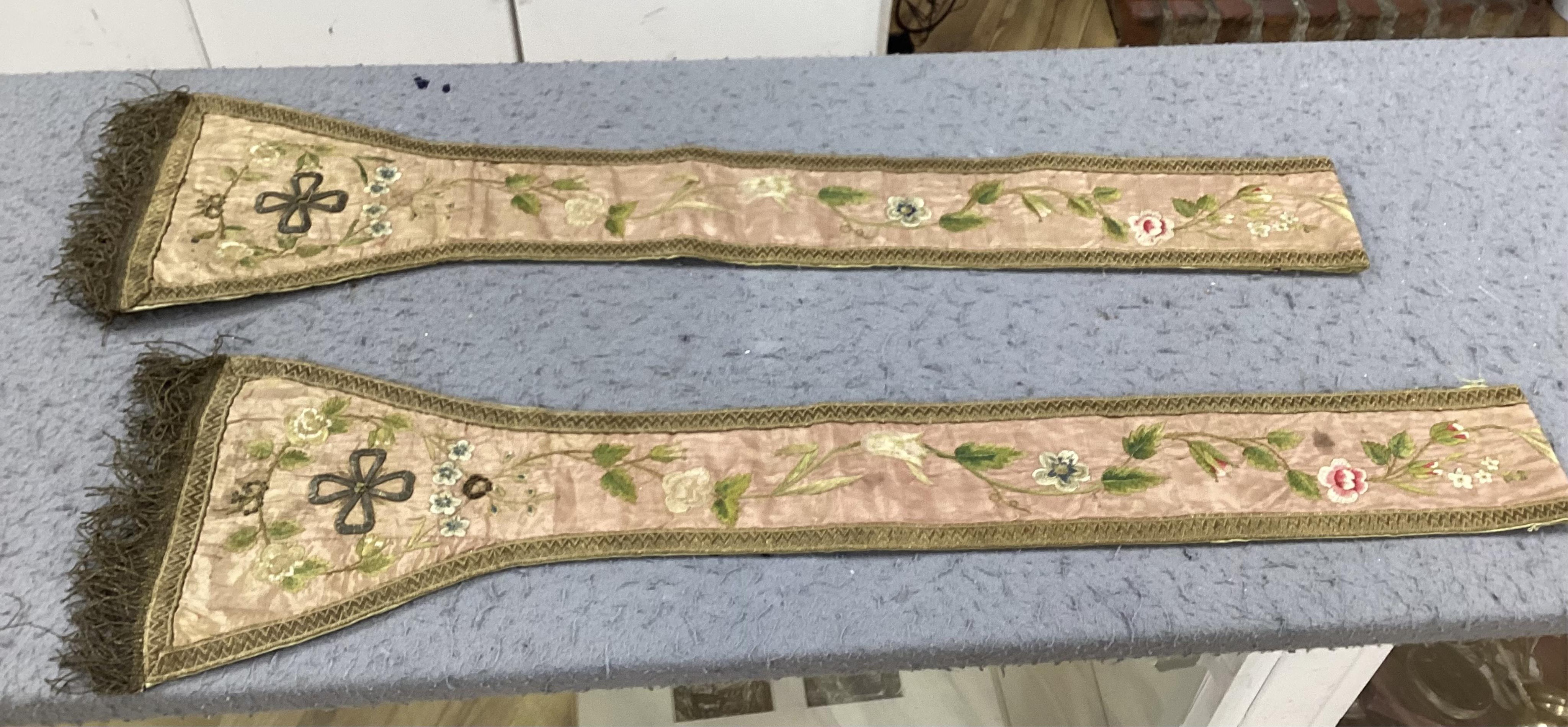 A collection of 18th and 19th century textiles, to include religious Maniples, two cushions, an embroidered chain stitch table cover with intricate edging, a Chinese embroidered panel and floral painted satin. Condition
